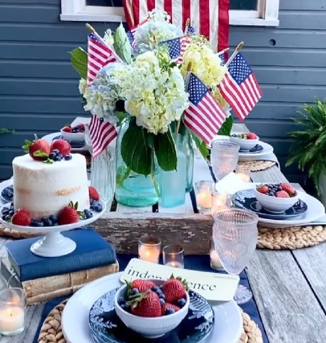 @littlehouseonchestnut - 4th of July tablescape with naked layer cake, hydrangea and American flags, and farmhouse style. #4thofjulytablescape