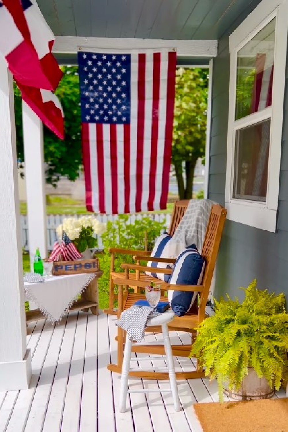 @littlehouseonchestnut - Kara's beautiful patriotic front porch with American flag, bunting, and vintage Pepsi crate. #4thofjulydecor