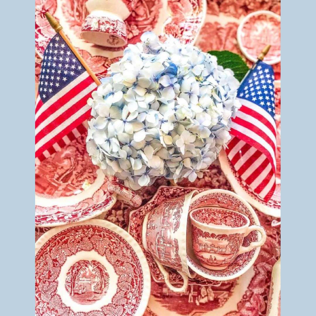 @suzannezinggstyle - 4th of July tablescape inspiration with red transferware dishes, blue hydrangea, and flags. #4thofjulytablescape