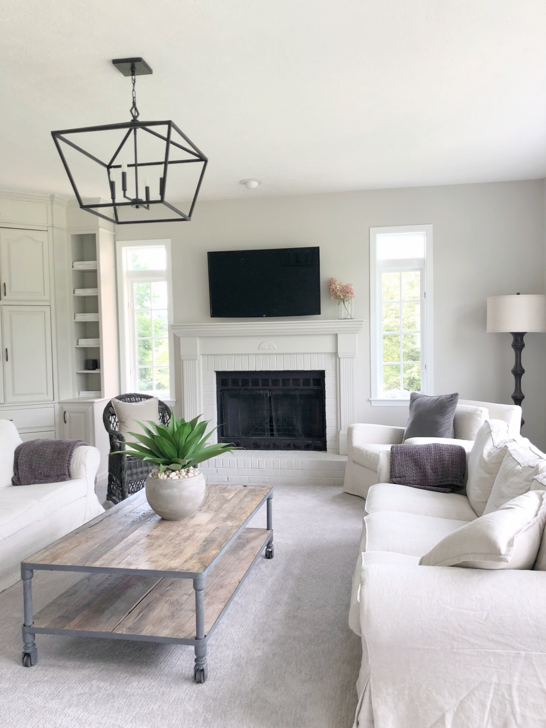 SW Agreeable Gray in tonal family room with built-ins and Belgian linen - Hello Lovely Studio. #swagreeablegray