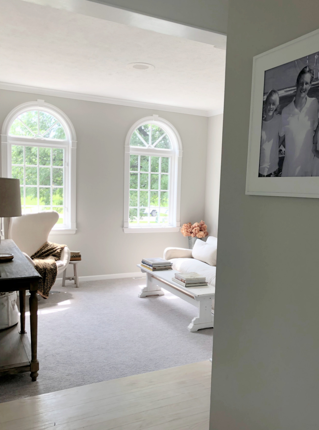 SW Repose Gray in living room with Belgian linen sofa, egg chair, and arched windows - Hello Lovely Studio. #reposegray #belgianstyle