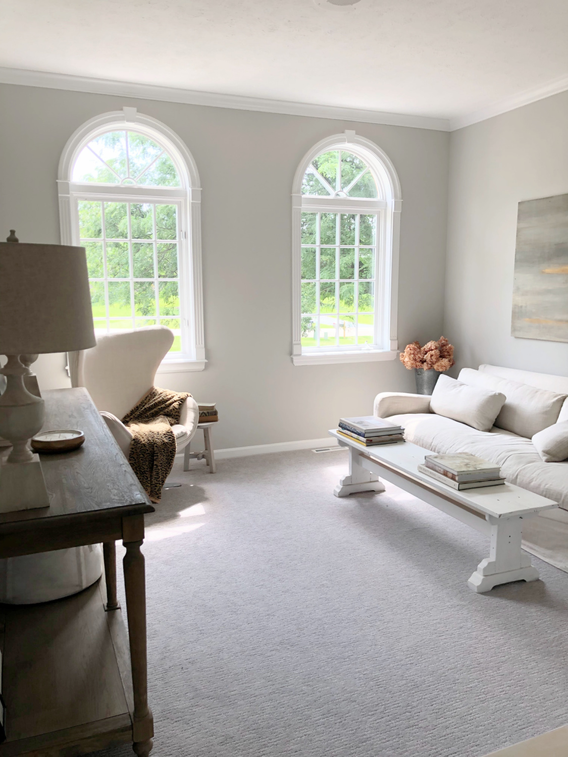 SW Repose Gray in living room with Belgian linen sofa, egg chair, and arched windows - Hello Lovely Studio. #reposegray #belgianstyle