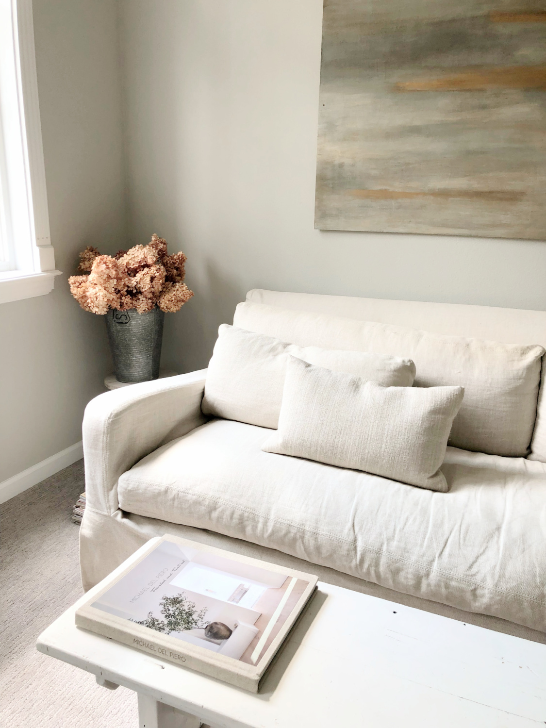 SW Repose Gray in living room with Belgian linen sofa, egg chair, and arched windows - Hello Lovely Studio. #reposegray #belgianstyle