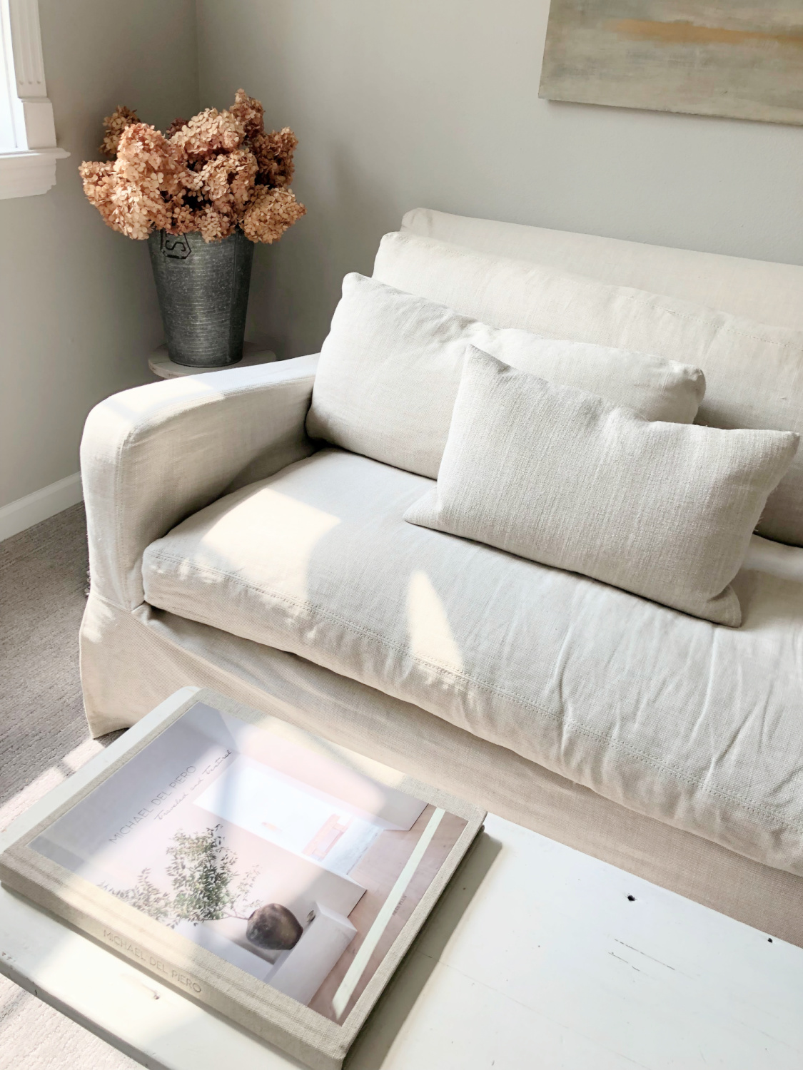 SW Repose Gray in living room with Belgian linen sofa, egg chair, and arched windows - Hello Lovely Studio. #reposegray #belgianstyle