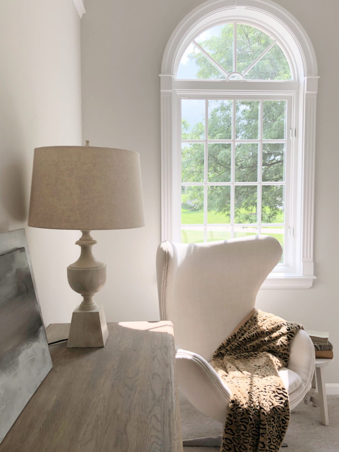 SW Repose Gray in living room with Belgian linen sofa, egg chair, and arched windows - Hello Lovely Studio. #reposegray #belgianstyle