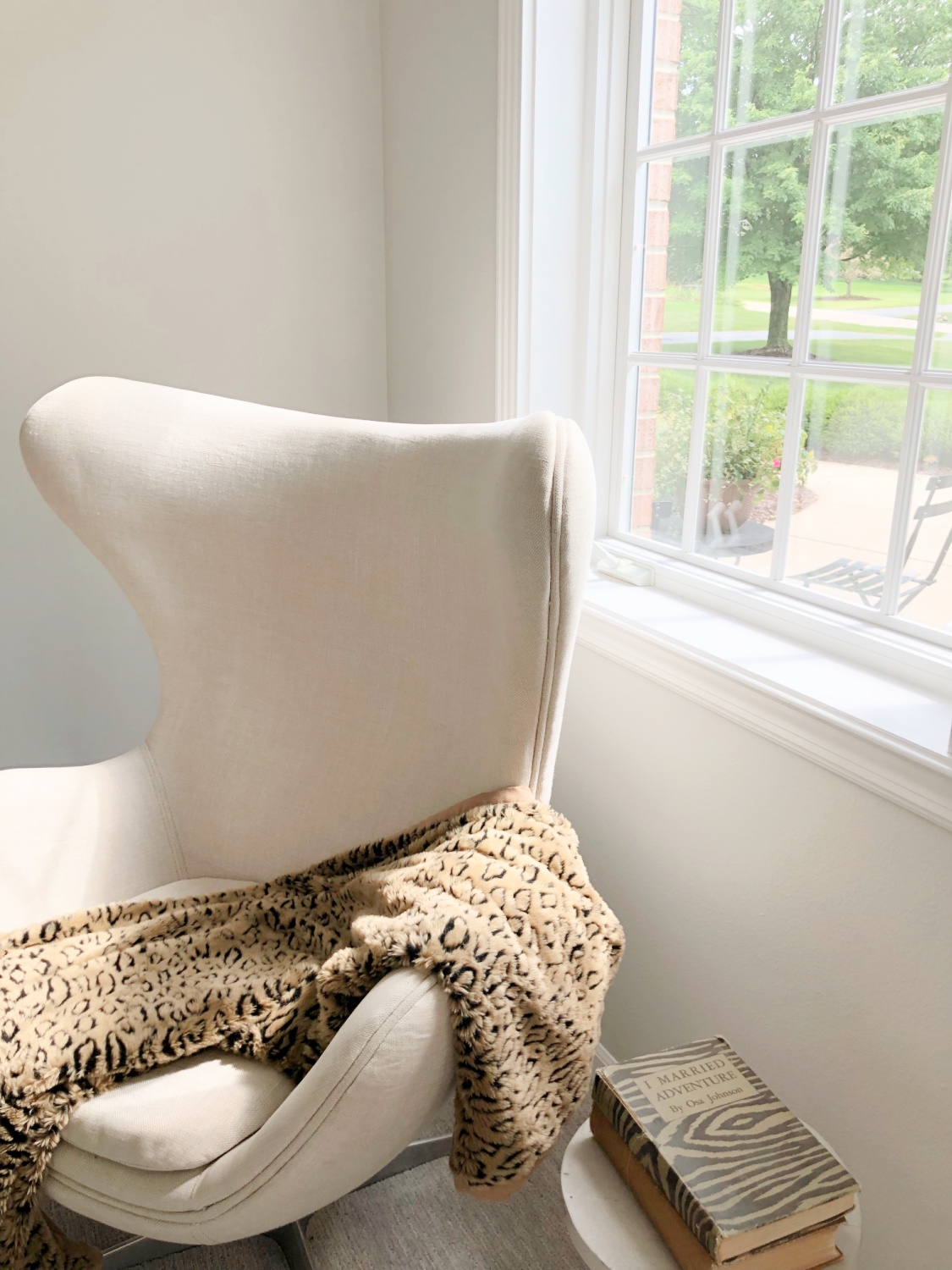 SW Repose Gray in living room with Belgian linen sofa, egg chair, and arched windows - Hello Lovely Studio. #reposegray #belgianstyle