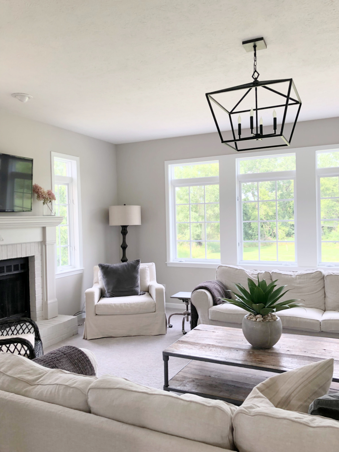 SW Agreeable Gray in tonal family room with built-ins and Belgian linen - Hello Lovely Studio. #swagreeablegray