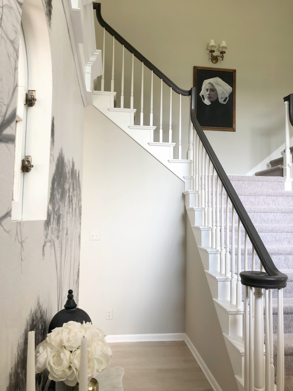 Sherwin-Williams Repose Gray in our two story entry with curving staircase and tree wallpaper - Hello Lovely Studio. #modernfrench #reposegray