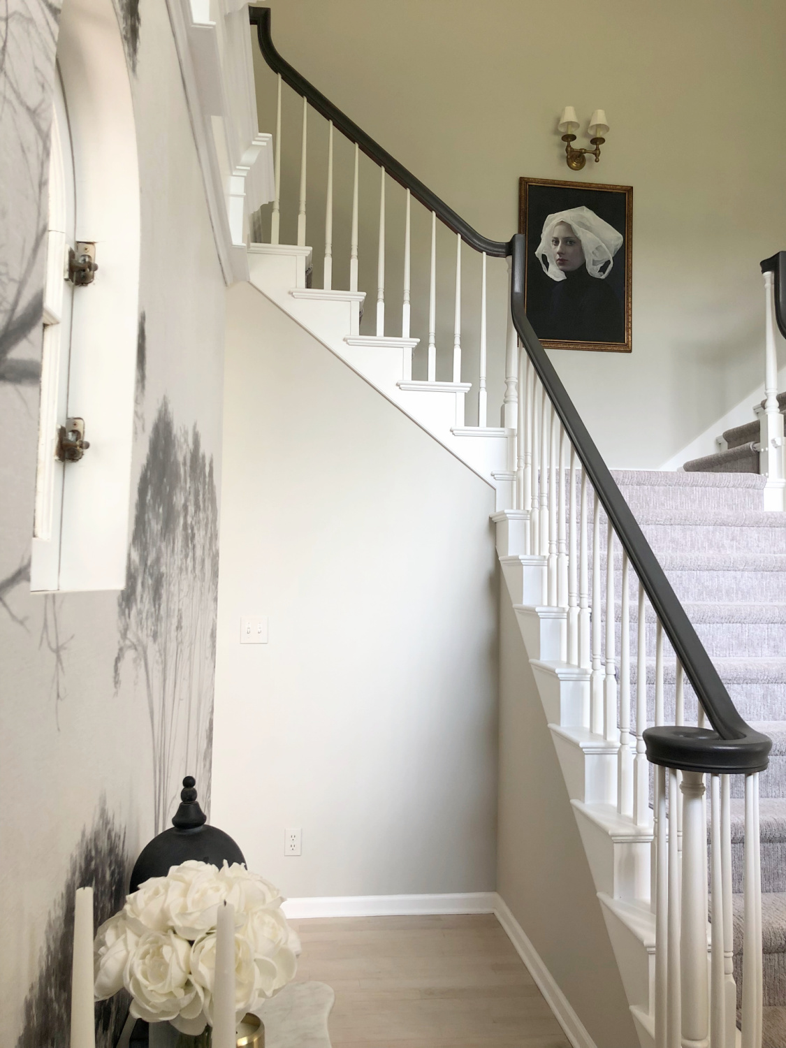 Sherwin-Williams Repose Gray in our two story entry with curving staircase and tree wallpaper - Hello Lovely Studio. #modernfrench #reposegray