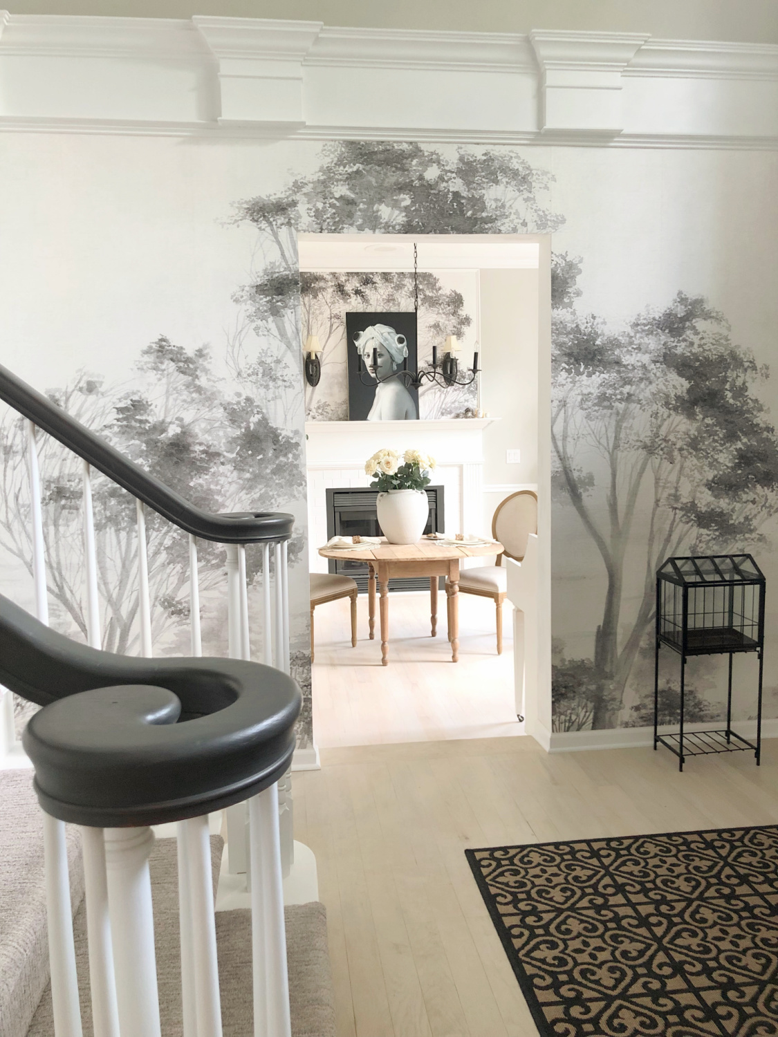 Grisaille tree wallpaper in the entry and dining room of our modern French home - Hello Lovely Studio. #treewallpaper #modernfrench