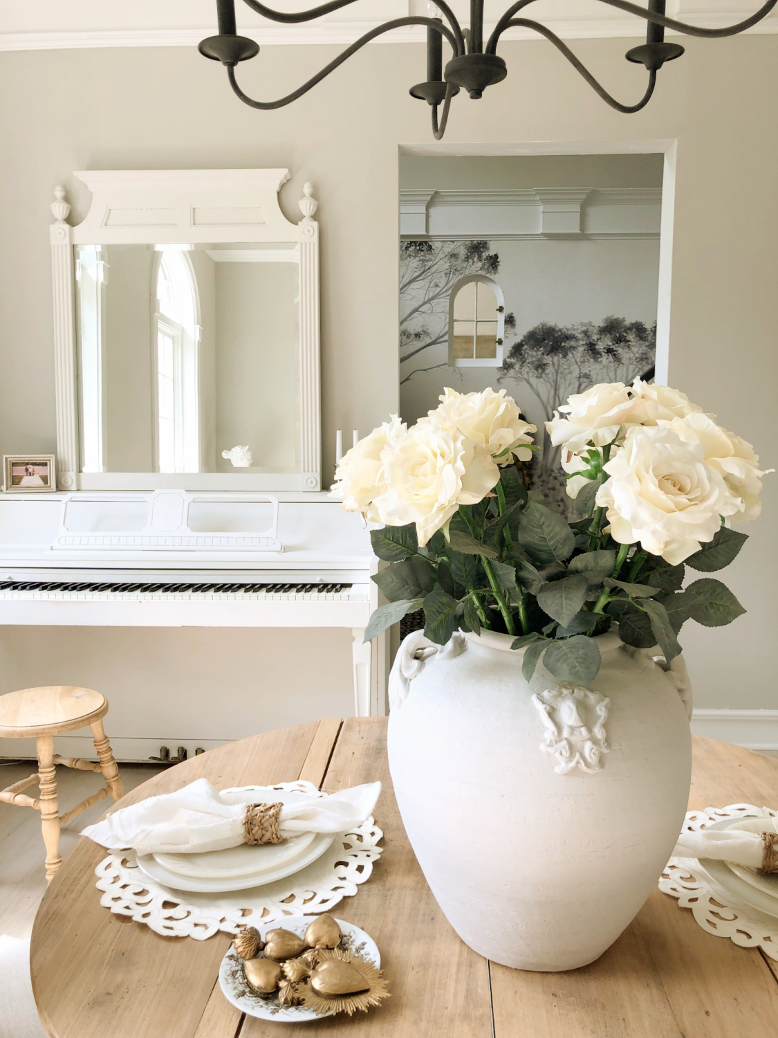 Sherwin-Williams Repose Gray in my modern French dining room with white piano and white roses - Hello Lovely Studio. #modernfrench #reposegray