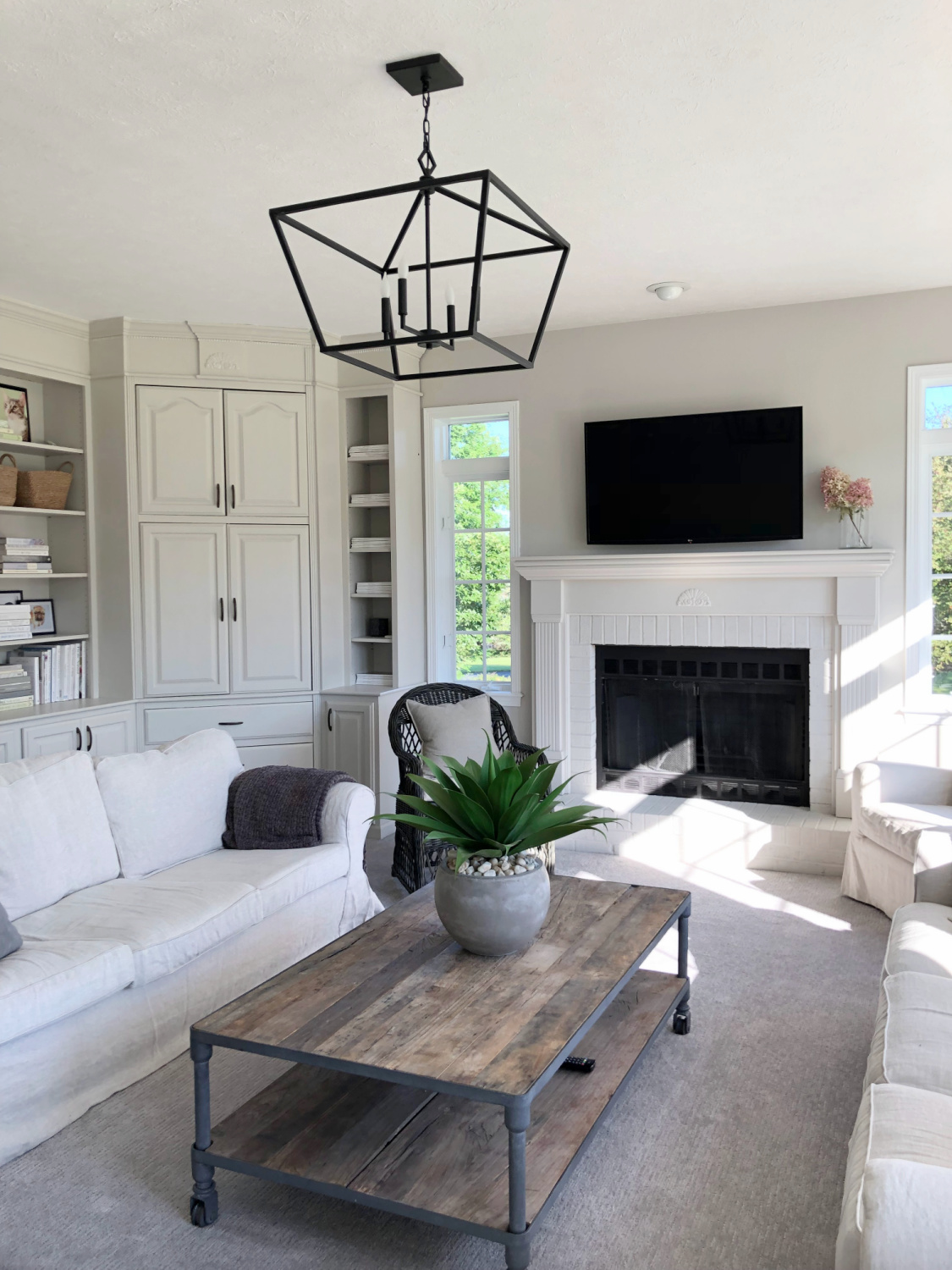 SW Agreeable Gray in tonal family room with built-ins and Belgian linen - Hello Lovely Studio. #swagreeablegray