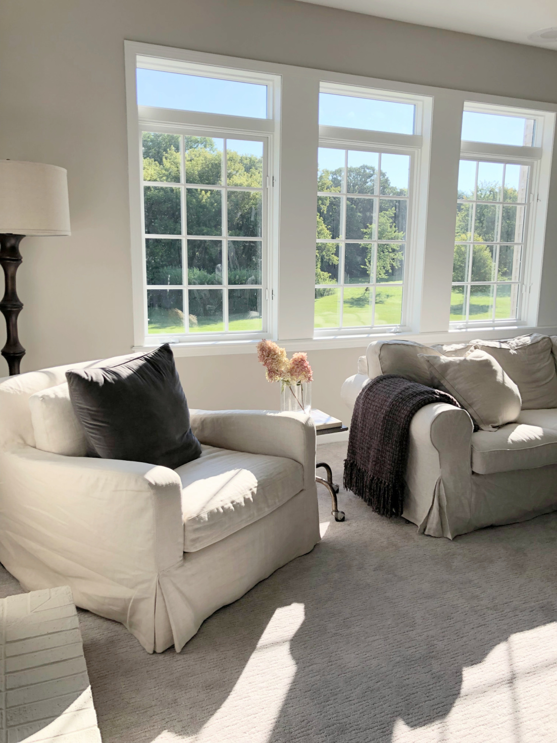 SW Agreeable Gray in tonal family room with built-ins and Belgian linen - Hello Lovely Studio. #swagreeablegray