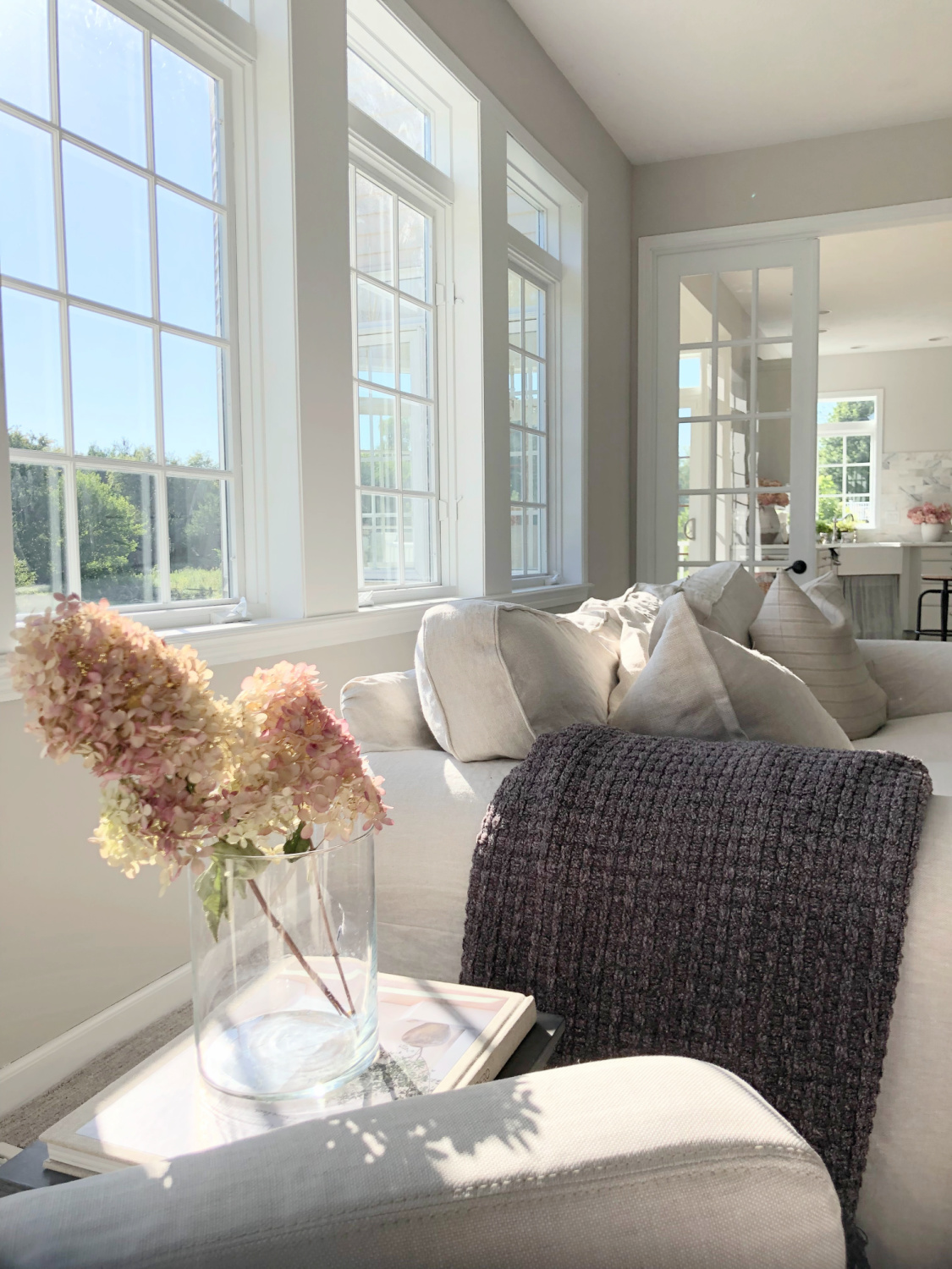 SW Agreeable Gray in tonal family room with built-ins and Belgian linen - Hello Lovely Studio. #swagreeablegray