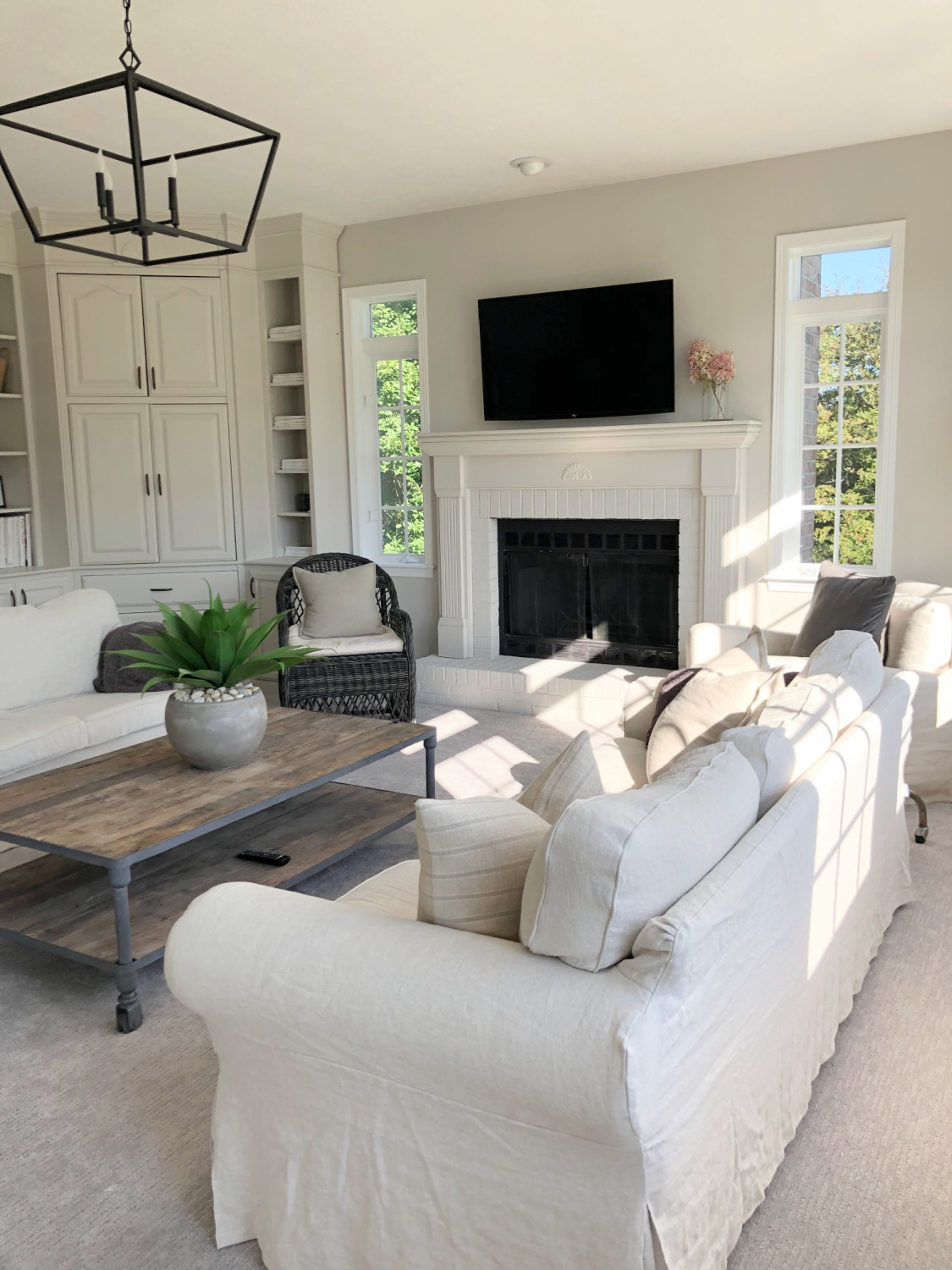 SW Agreeable Gray in tonal family room with built-ins and Belgian linen - Hello Lovely Studio. #swagreeablegray