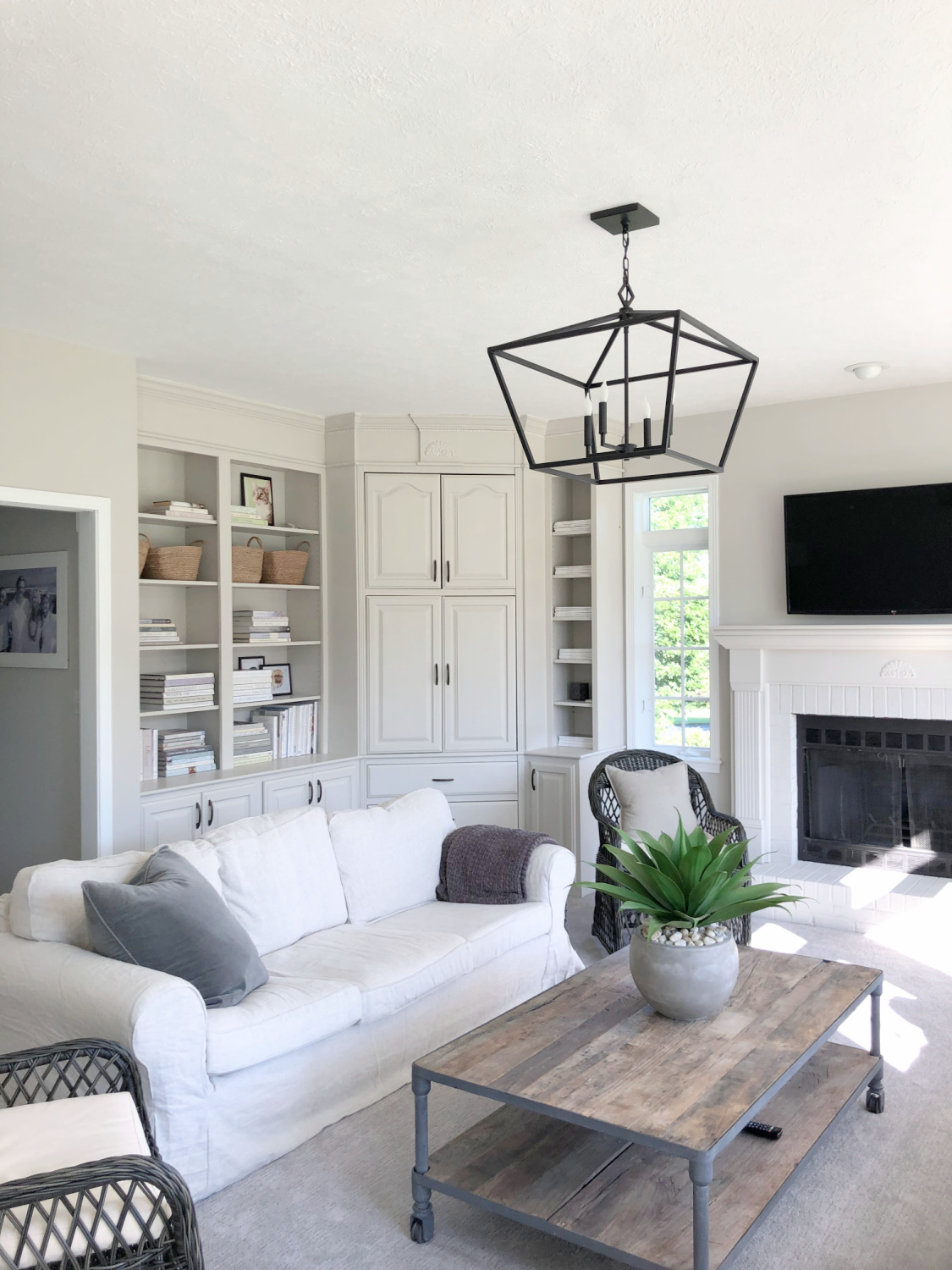 SW Agreeable Gray in tonal family room with built-ins and Belgian linen - Hello Lovely Studio. #swagreeablegray