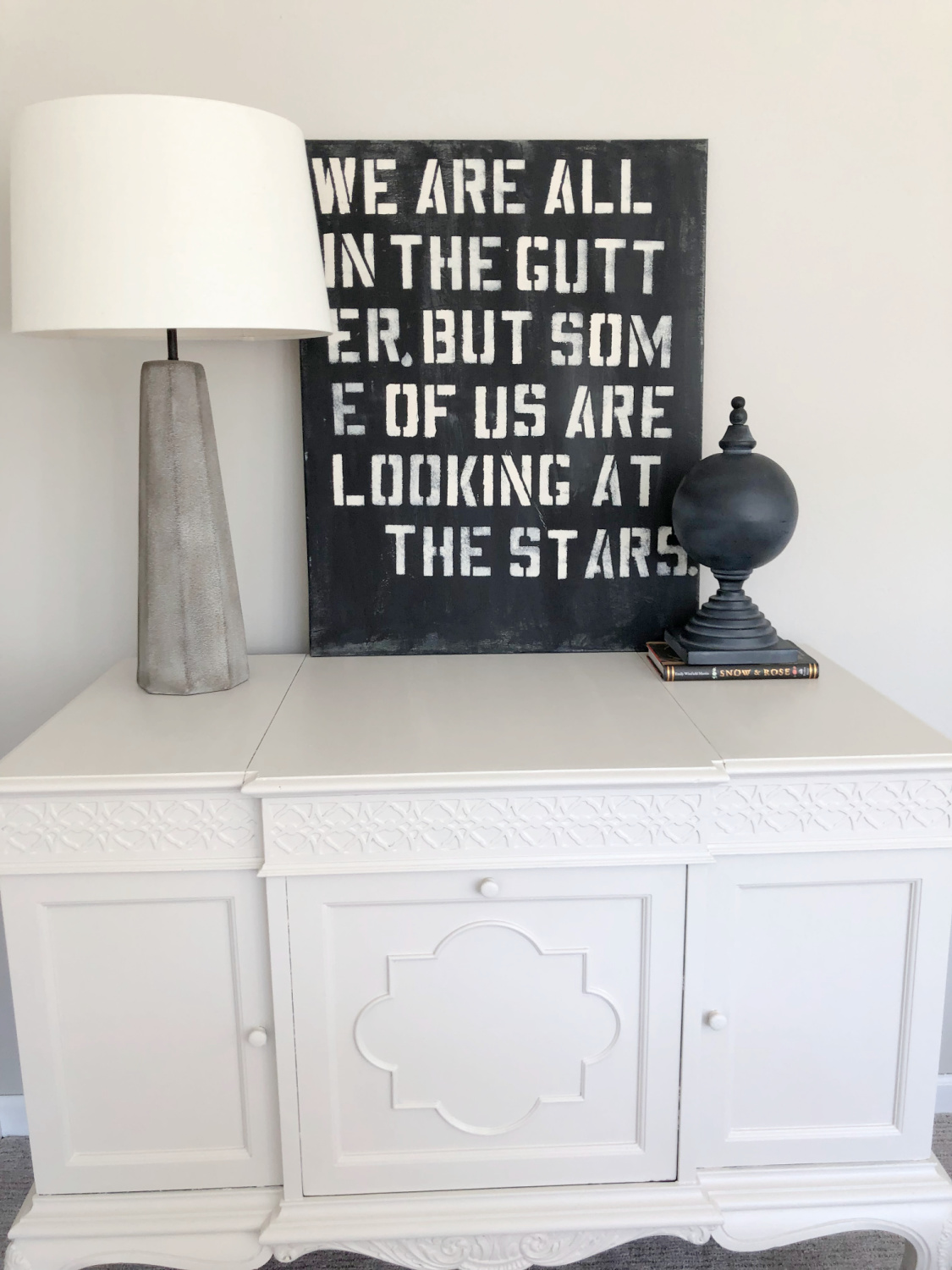 My painting of an Oscar Wilde quote on an antique victrola cabinet in our family room painted SW Agreeable Gray - Hello Lovely Studio.