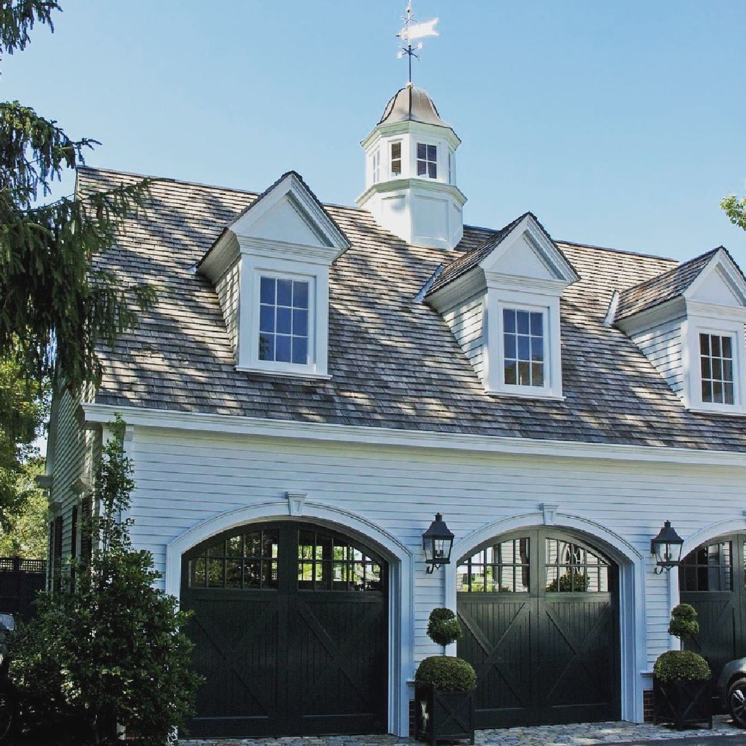@andreozzi - stunning white carriage house exterior with arched garage door openings and dormers. #classicarchitecture #whitehouses