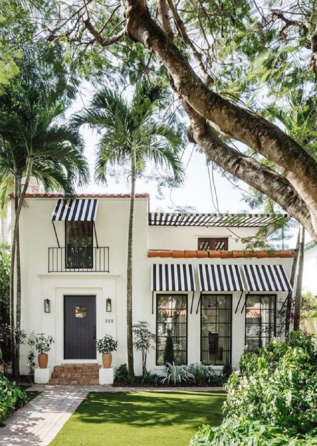 @calimiahome - stunning white house exterior with black stripe awnings and door. #californiahomes #blackandwhitehomes