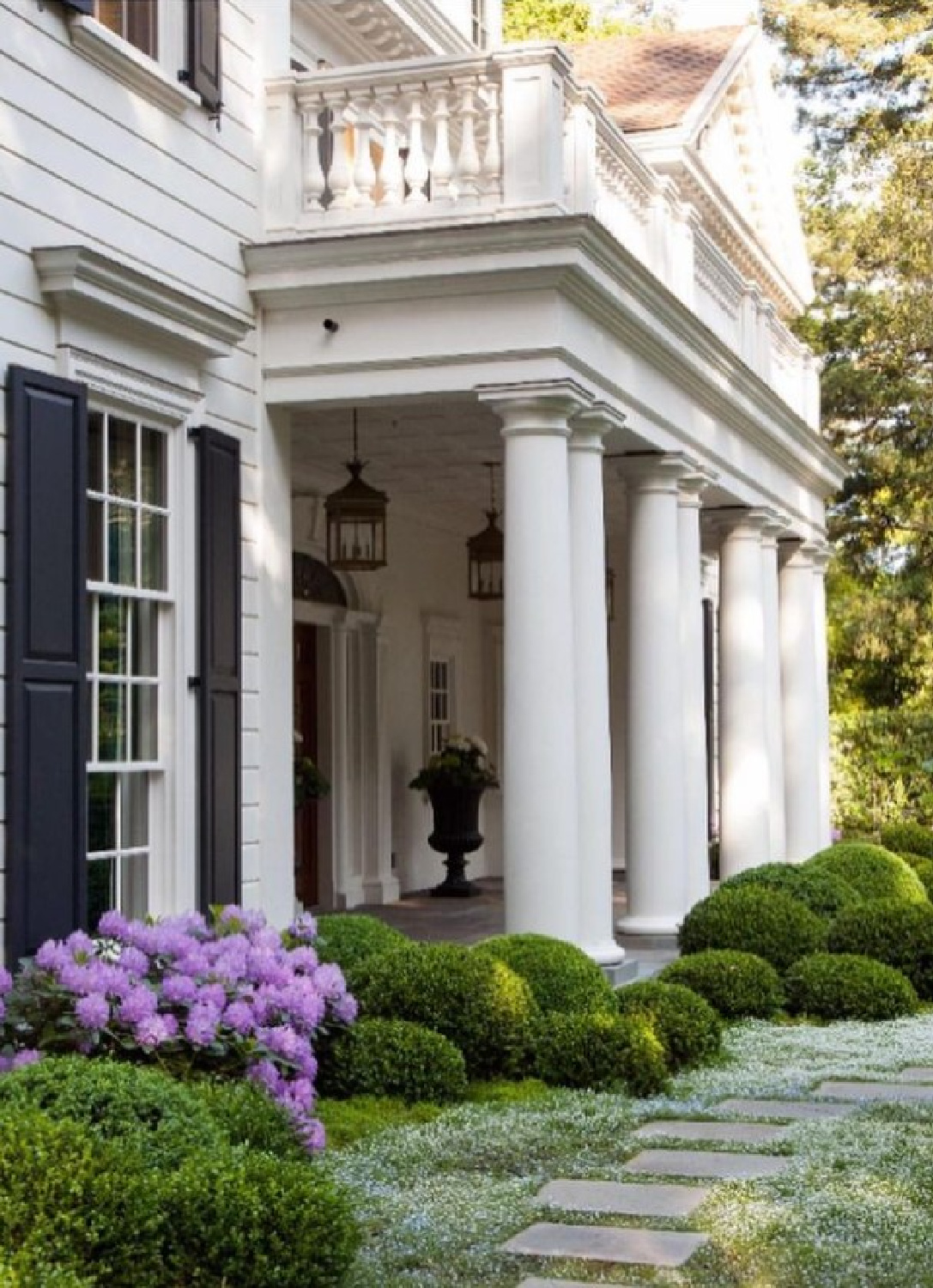 @charliebarnettassociates and @elizabetheverdellgardendesign - Stunning white house exterior with wide column entry and boxwood. #classicarchitecture #whitehouses #whitehouseexteriors