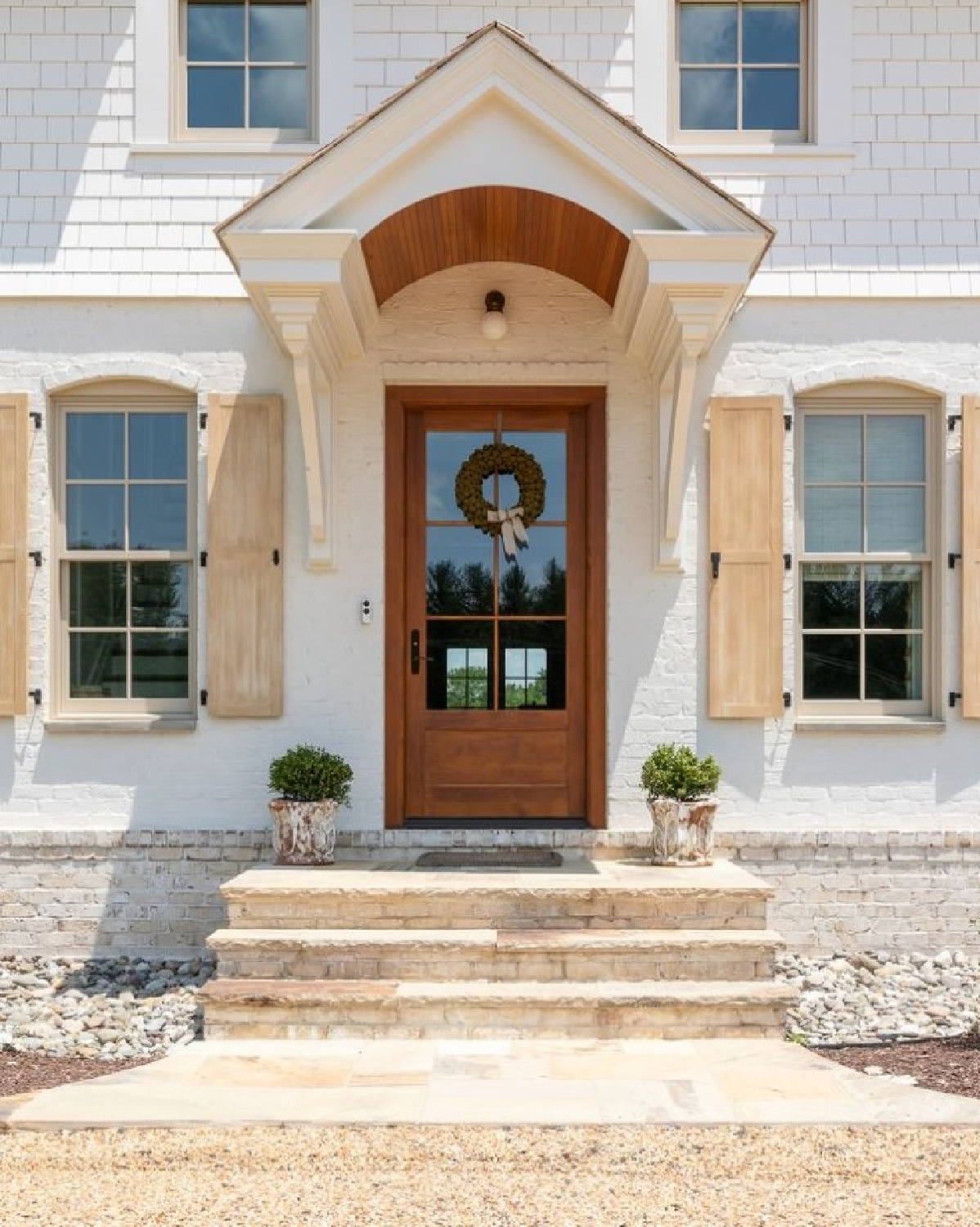 BM China White on a beautiful new house exterior with shutters and stone - @christykosnicphotography. #whitehouseexteriors #bmchinawhite