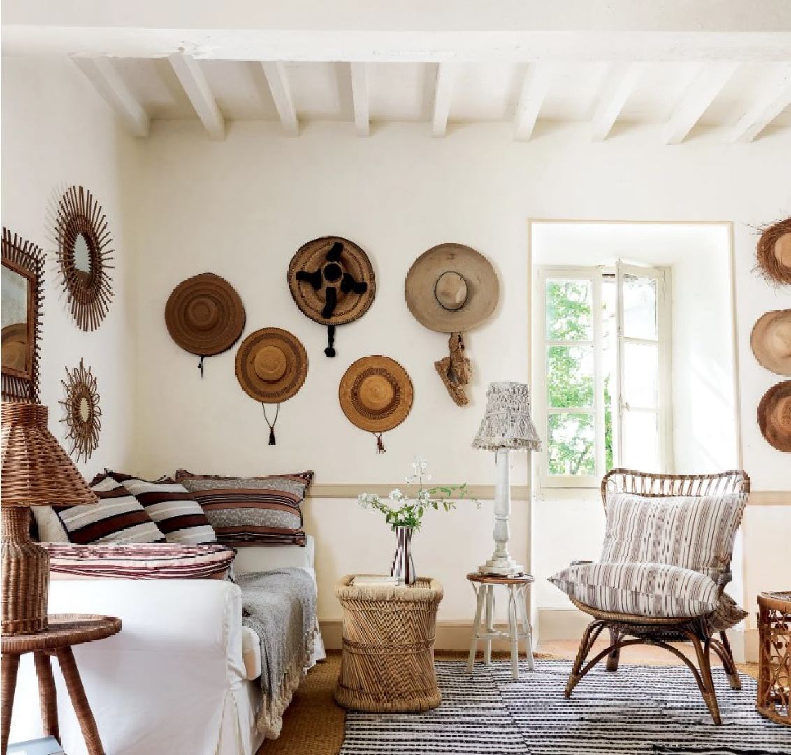 Eclectic living room with baskets on walls and rustic wood beams in a 19th century French cottage in Toulouse by Lucinda Chambers - photo by Paul Massey. #frenchcottage #frenchfarmhouse #interiordesign