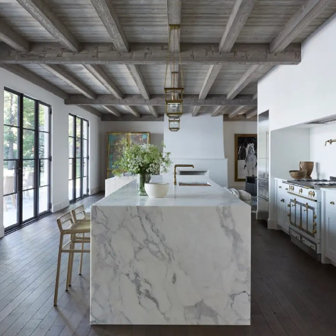 Rustic wood ceiling over marble waterfall kitchen island. Interior design by Michael Del Piero (Richard Powers - photo) for TRAVELED AND TEXTURAL (Beta-Plus, 2023). #modernrustic #michaeldelpiero