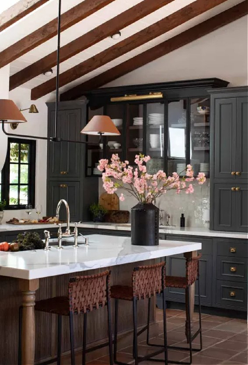 Park and Oak designed beautiful kitchen with deep blue-black cabinets, rustic wood beams, and classic traditional details. #blackcabinets #sophisticatedkitchen