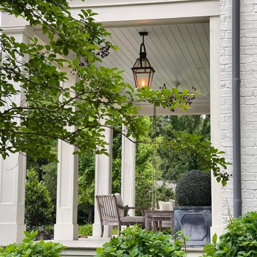 @shopgloriette - Beautiful white porch with columns, lantern, and greenery. #whiteporches