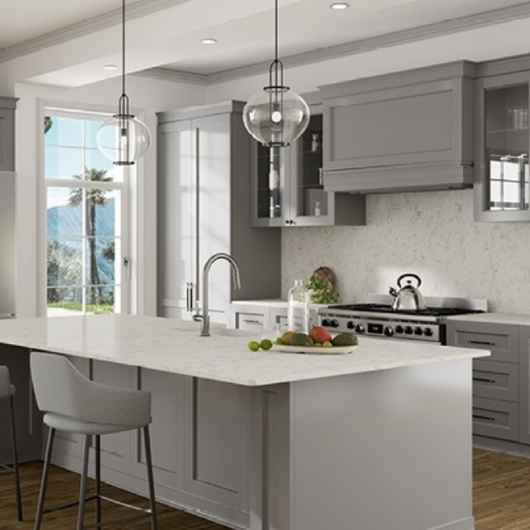 Cantata quartz (Viatera) white counters on an island in a kitchen. #cantataquartz #viaterausa