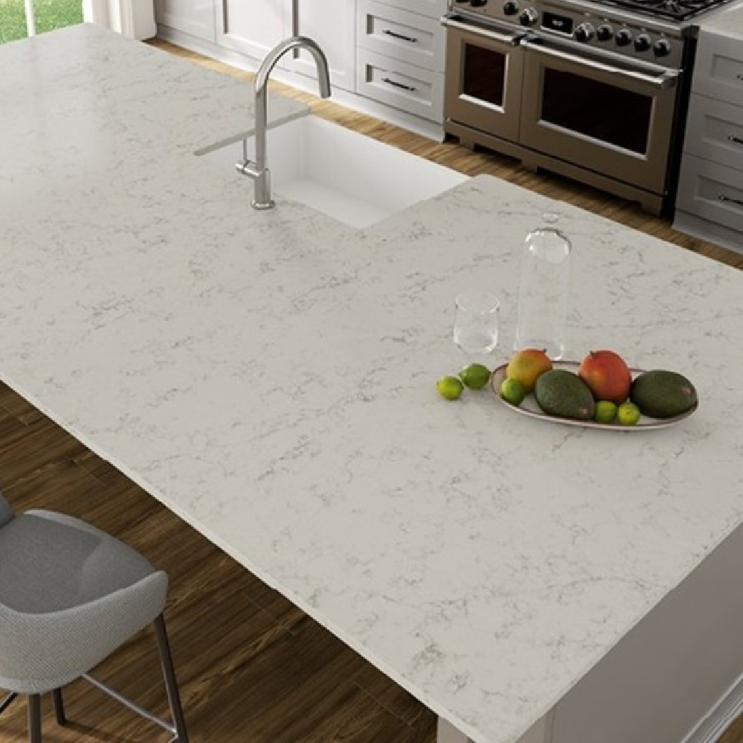 Cantata quartz (Viatera) white counters on an island in a kitchen. #cantataquartz #viaterausa