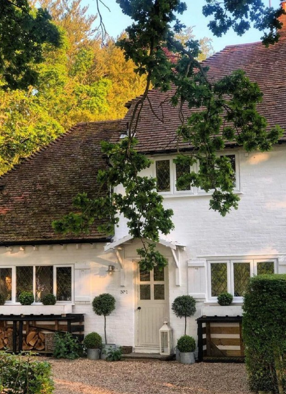 @vintage.white - Beautiful white brick house exterior with topiaries flanking front door. #whitepaintedbrick #whitebrickhouses