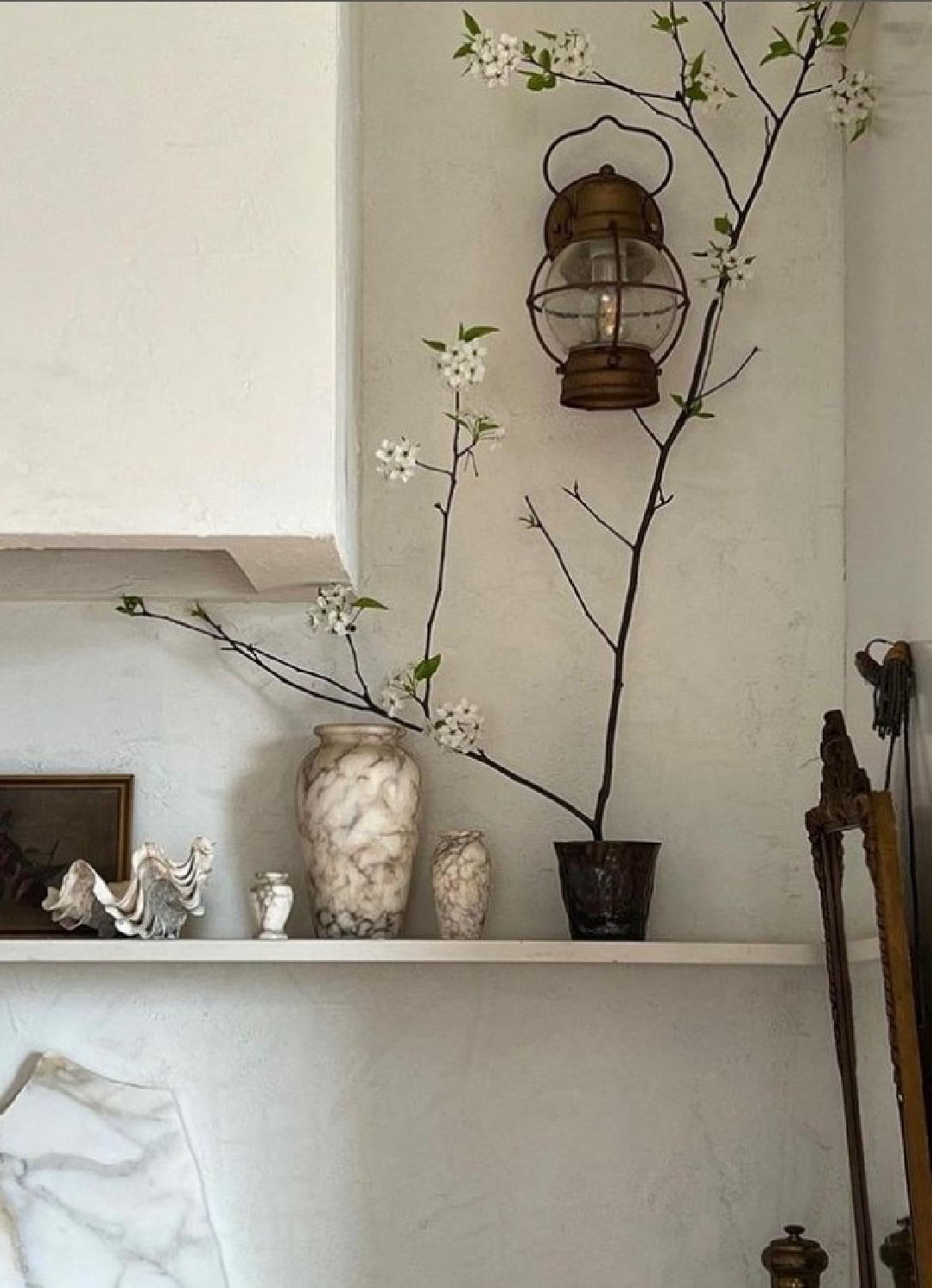 Artful white kitchen vignette with plaster range hood and marble vessels - @erinashkelly. #modernrustic #moderncountrykitchen #europeancountrystyle