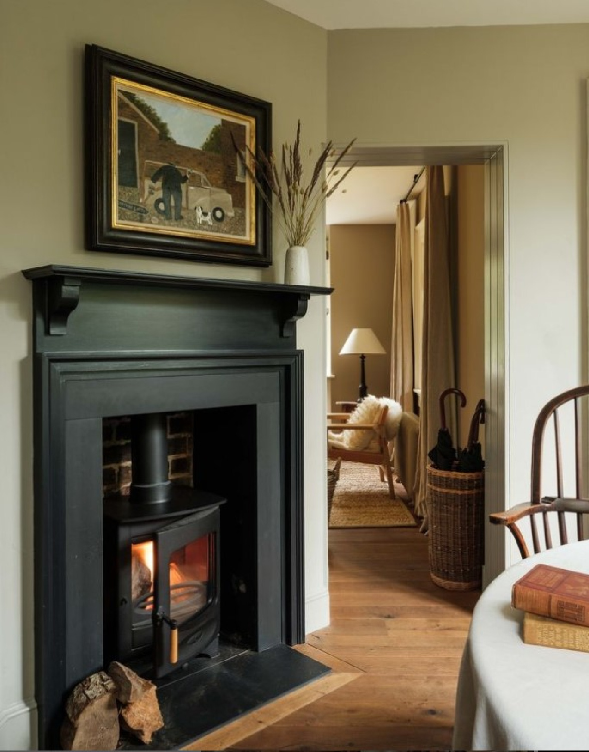 Heckfield Place - black fireplace surround in a cozy room.