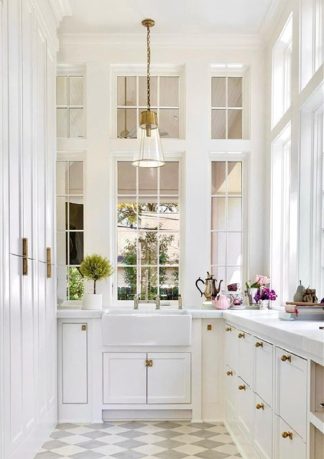 Magnificent white pantry with checkered floor and windows all around - Holly Bell Design. #pantrygoals #butlerpantries #whitekitchenpantries