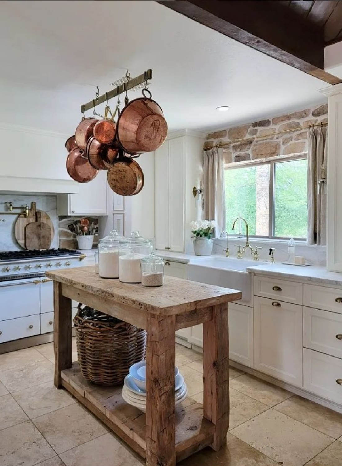 @thefrenchnestcointeriordesign French farmhouse kitchen with reclaimed wood island and copper pots hanging above. #frenchfarmhouse #frenchkitchens