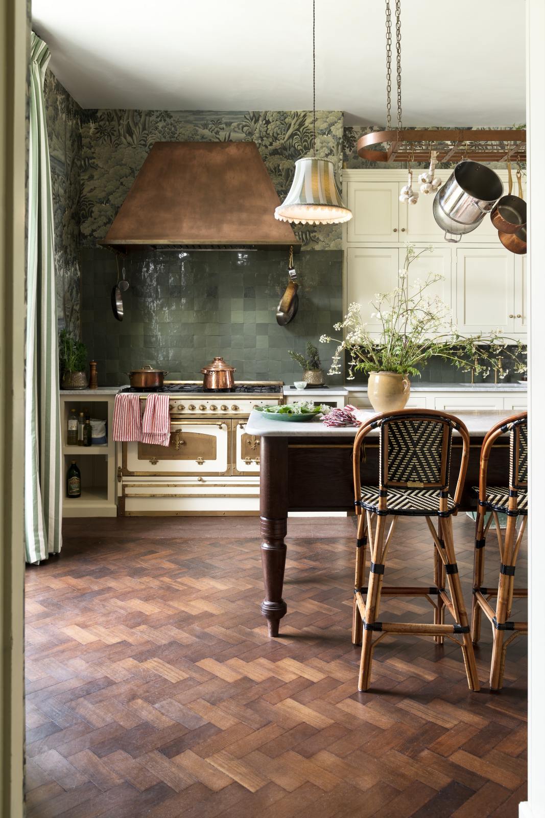 Pale green cabinets, copper hood over Italian range, marble topped Dairy Table, and deep moody green tile backsplash in the English country kitchen renovated with deVOL at Castle Trematon with House of Hackney wall covering and design. #devolkitchens #castletrematon