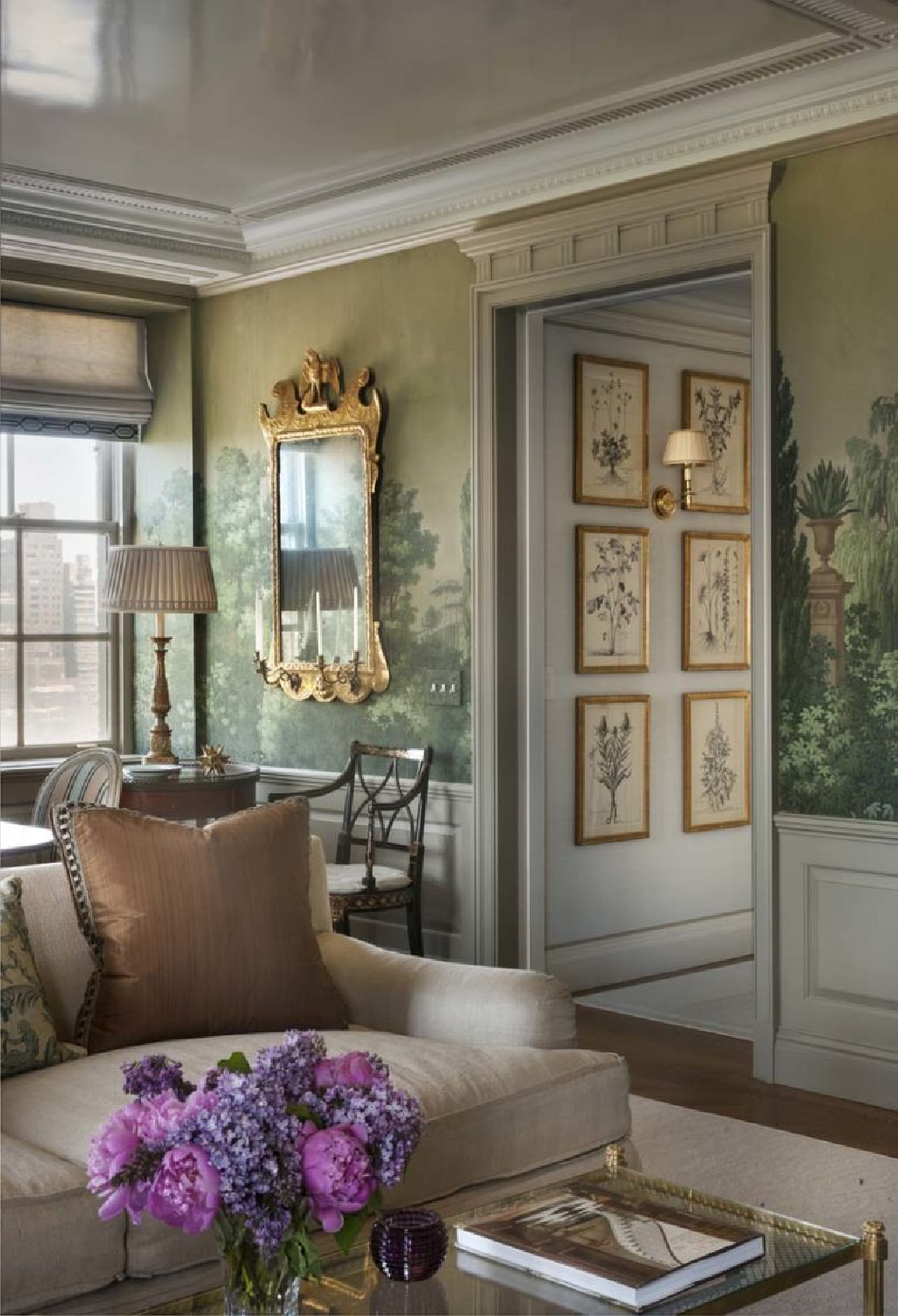 Zuber mural with green is a lush escape in a Manhattan living space with botanicals in gilded frames - Cathy Kincaid Interiors.