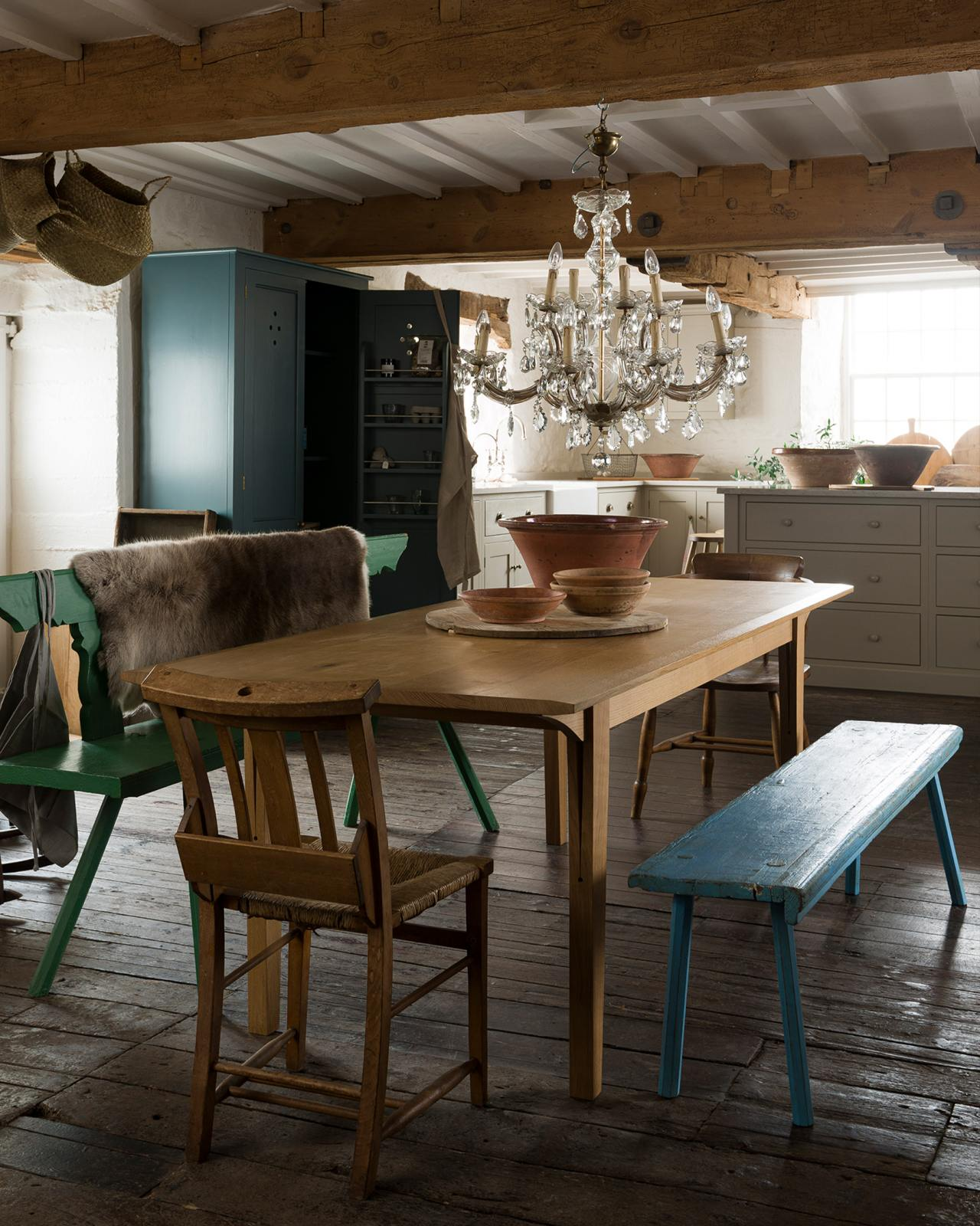 Beautiful English country rustic elegant kitchen with bespoke design by deVOL including their Peg Leg Table seen here with painted blue bench. #englishkitchens #englishcountry