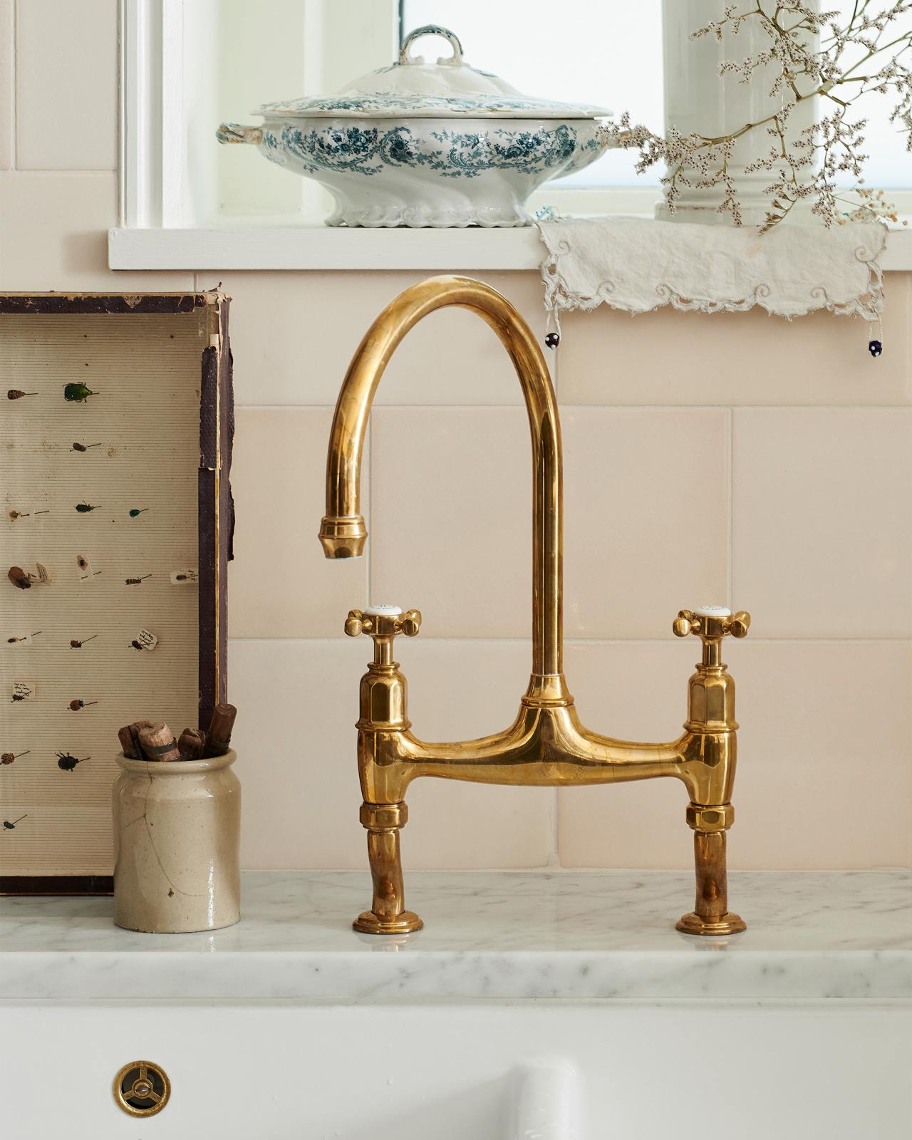 Brass Ionian Taps and blush pink backsplash tile in an English kitchen, deVOL. #englishcountrykitchens #bespokekitchens #devolkitchens