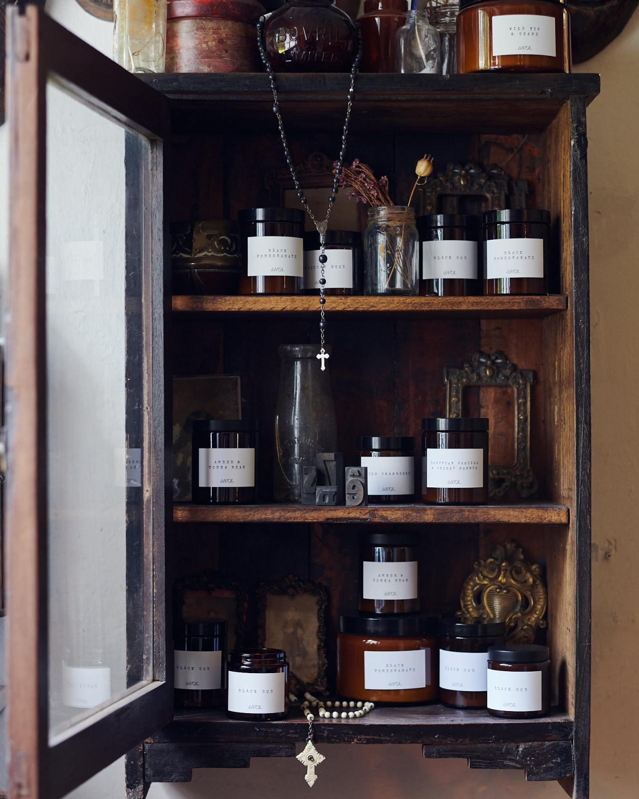 Vintage cabinet full of candles from deVOL in amber glass. #devolkitchens #devolcandles