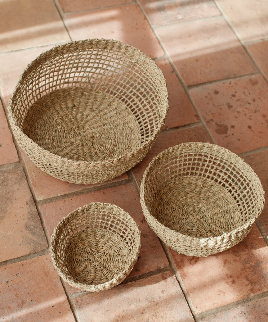 Seagrass Produce Bowls on a terracotta tile floor - Jenni Kayne Home. #seagrassbowl #warmmodernrustic #rustickitchen