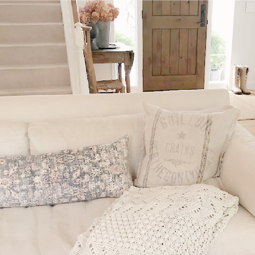 Hello Lovely living room with Belgian linen sofa, Montara pillow (Amber Lewis x Loloi), and vintage grainsack pillow. #europeancountry #modernrusticliving