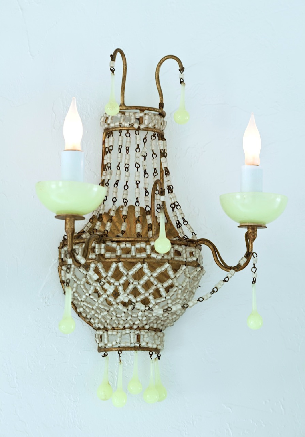 Vintage sconce with lovely jade green and crystals. Serene, romantic, ethereal white interior from Fifi O'Neill's SHADES OF WHITE (CICO Books, 2021). #fifioneill #whiteinteriors