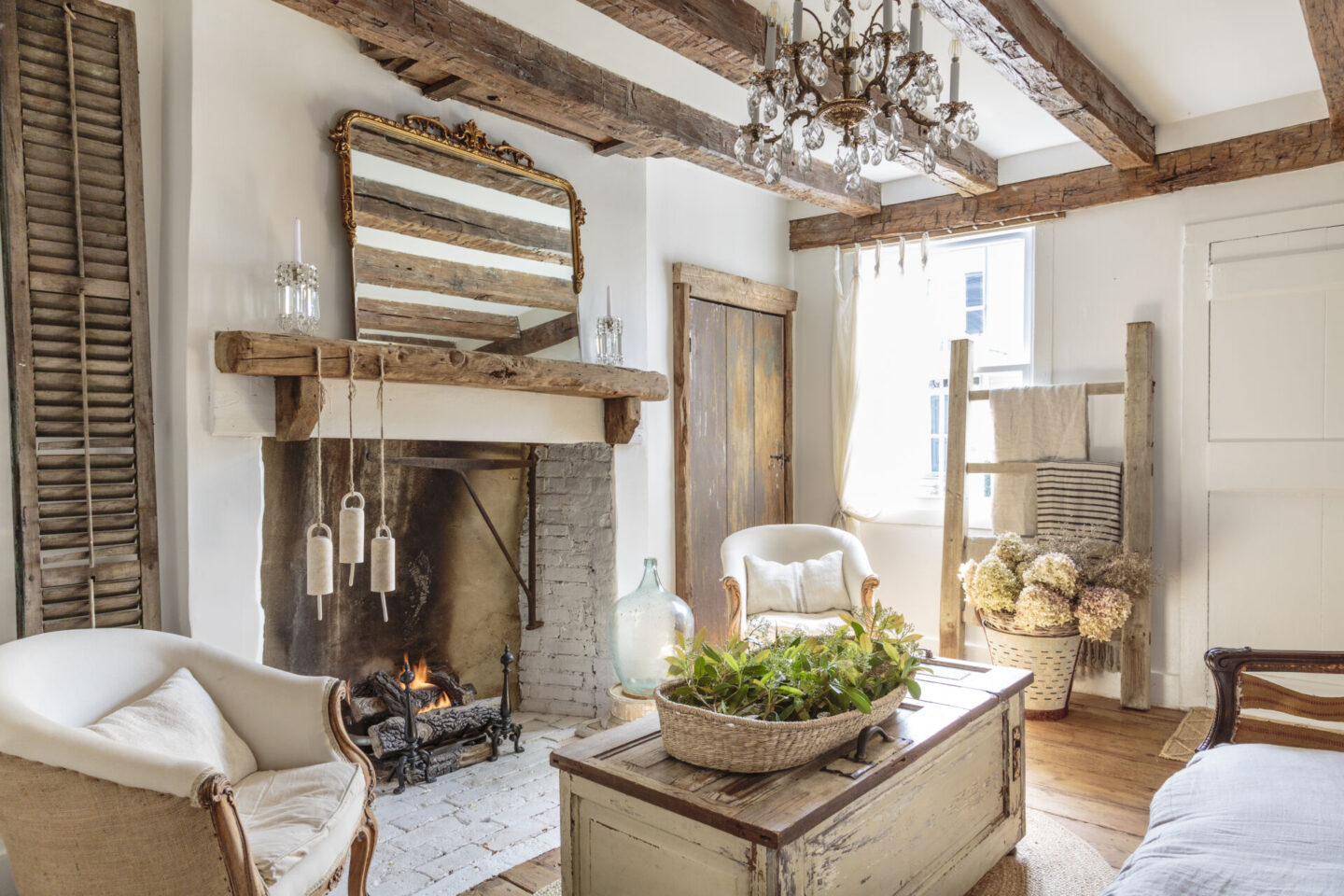 Rustic country living area with wood beams and fireplace - styling by Fifi O'Neill and photo by Mark Lohman.