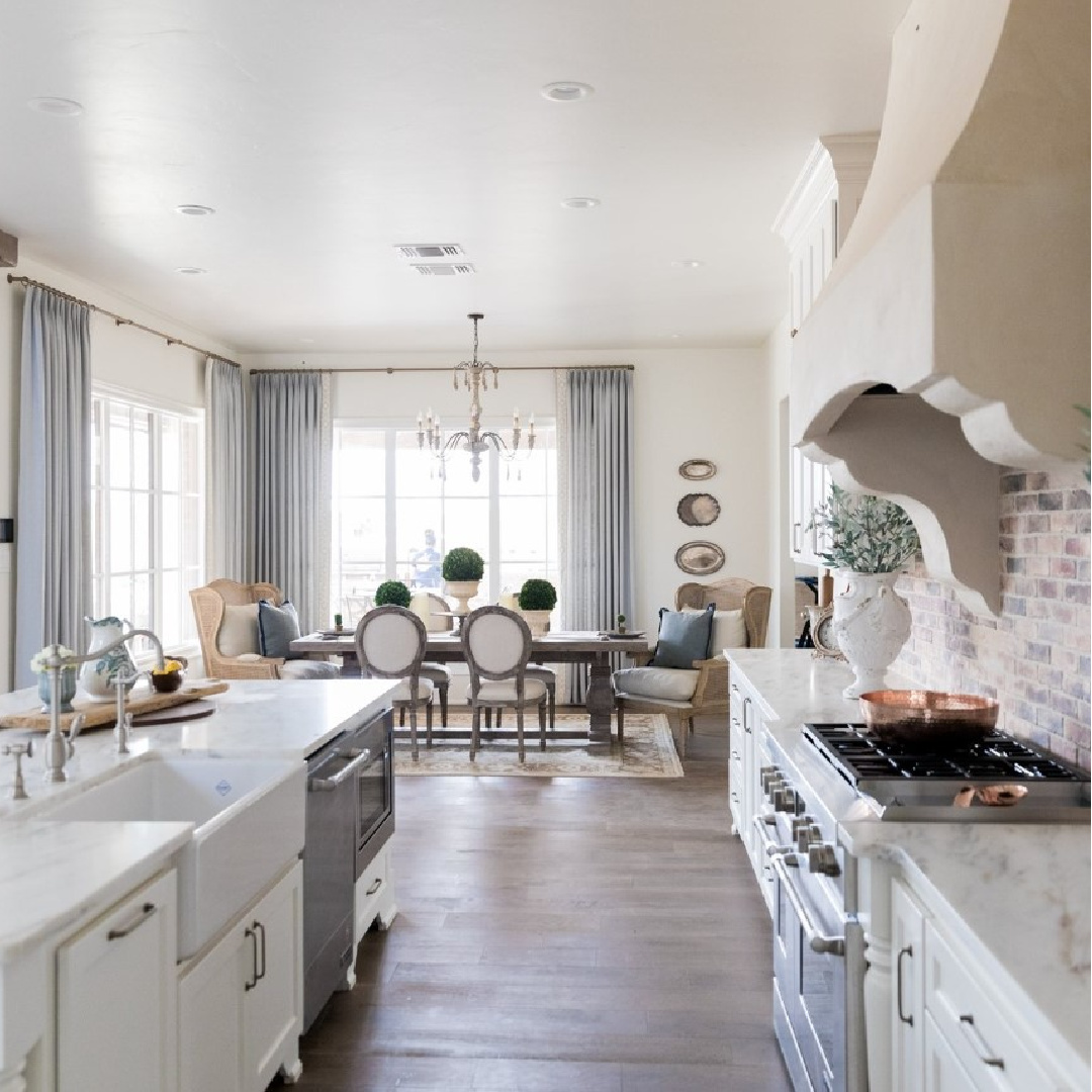 Sherwin-Williams Alabaster in a beautiful country French kitchen with Old World style and Chicago brick backsplash - design by Brit Jones. #swalabaster #modernfrench #frenchkitchen