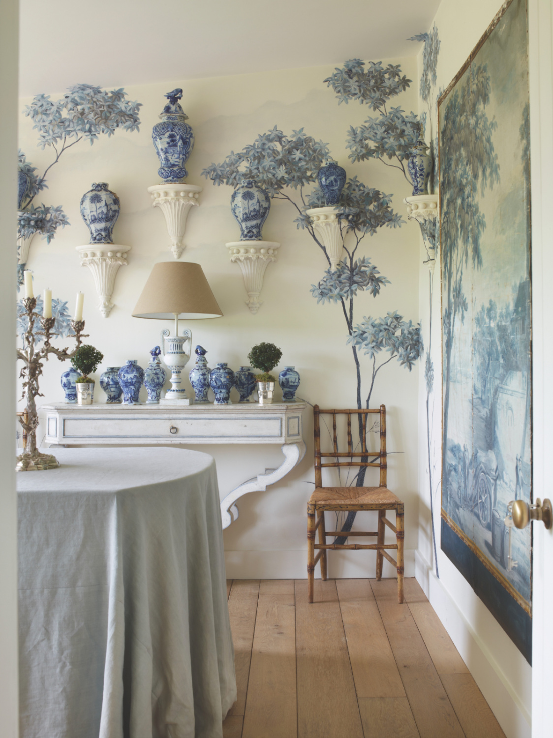 Blue leafy tree wall covering in a beautiful classic interior in Frederic Magazine Paola Moschino and Philip Vergeylen.