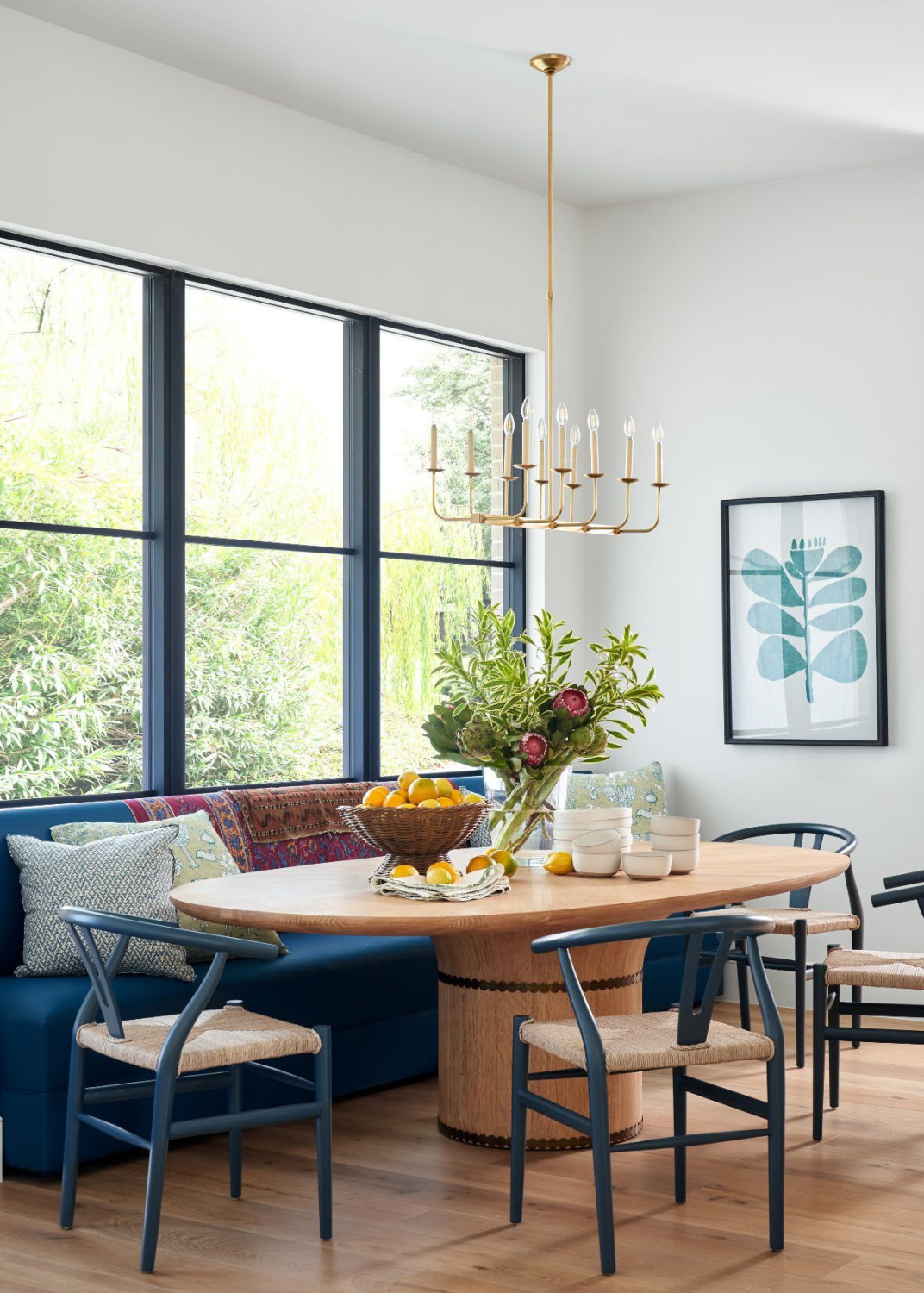 Kirsten Mullen designed breakfast nook with  bright blue banquette and wishbone chairs in Frederic Magazine. #breakfastnook