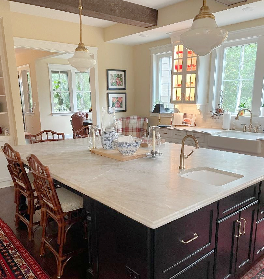 Hello Lovely - traditional kitchen with black island, white custom cabinets, Taj Mahal quartzite, farm sink, Bluestar range, and Chippendale stools. #traditionalkitchens #twotonekitchen