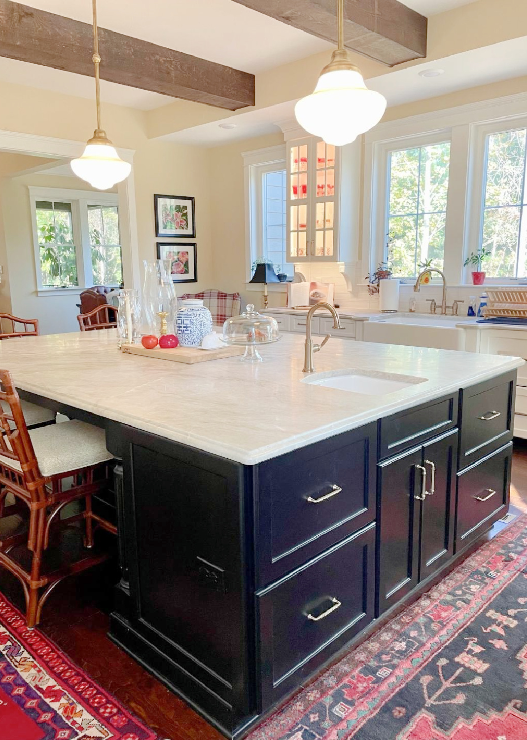 Hello Lovely - traditional kitchen with black island, white custom cabinets, Taj Mahal quartzite, farm sink, Bluestar range, and Chippendale stools. #traditionalkitchens #twotonekitchen